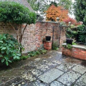 A timeless courtyard patio with simple planting makes for a low maintenance quiet space right in centre of Tenterden