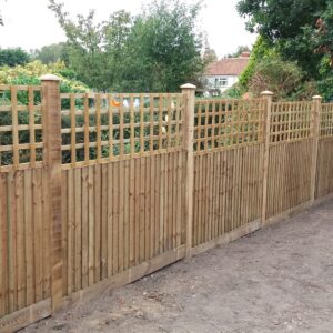 Closeboard fencing panels installed with a traditional square trellis top allows the wind to pass through whilst maintaining the boundary