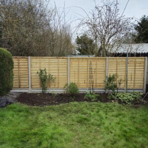 Waney lap panels installed on concrete posts and gravel boards provide a long-lasting boundary fence