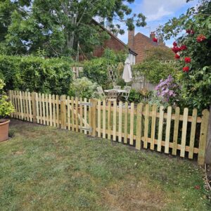 Palisade fencing is installed to divide the garden in order to keep the client's dog away from the patio beyond