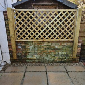 This lattice panel installed on posts hides the neighbours shed and provides a framework for climbing plants to thrive next to this shady patio